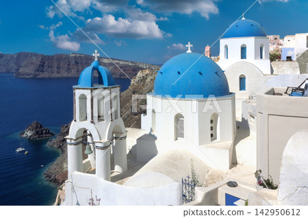 Iconic Blue Dome Churches of Santorini, Greece Overlooking the Aegean Sea Iconic Blue Dome Churches of Santorini, Greece Overlooking the Aegean Sea 142950612