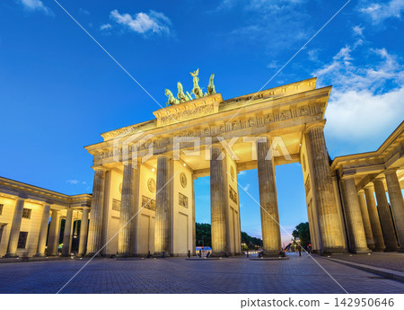 Brandenburg Gate in Berlin, Germany, illuminated at dusk with a blue sky Brandenburg Gate in Berlin, Germany, illuminated at dusk with a blue sky 142950646