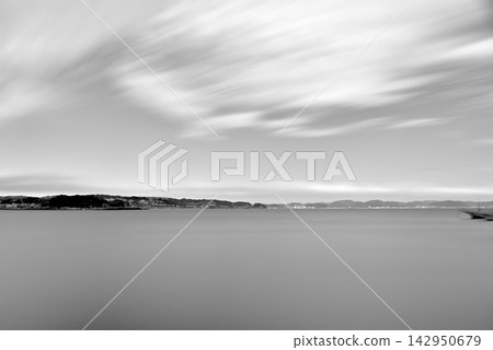 A long-exposure black and white photograph of Katase Higashihama Beach and the Shonan Sea, viewed from Enoshima Shonan Port North Green Space. 142950679