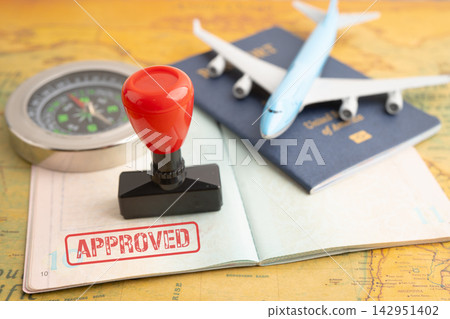 Passport with approved stamp on document for tourism to immigration at airport in country. Passport with approved stamp on document for tourism to immigration at airport in country. 142951402