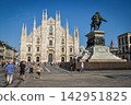 Milan Cathedral and the equestrian statue of Vittorio Emanuele II stand out against the blue sky. 142951825