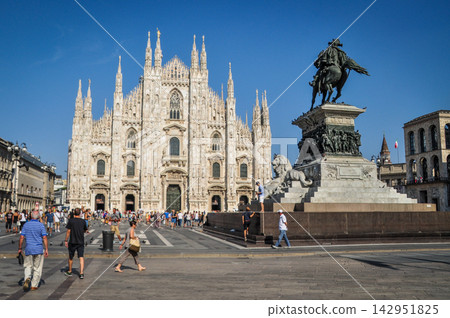 Milan Cathedral and the equestrian statue of Vittorio Emanuele II stand out against the blue sky. Milan Cathedral and the equestrian statue of Vittorio Emanuele II stand out against the blue sky. 142951825