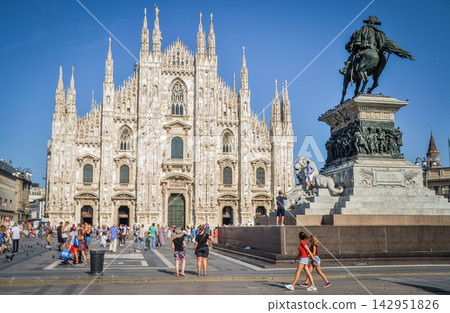Milan Cathedral and the equestrian statue of Vittorio Emanuele II stand out against the blue sky. Milan Cathedral and the equestrian statue of Vittorio Emanuele II stand out against the blue sky. 142951826