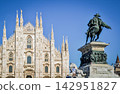 Milan Cathedral and the equestrian statue of Vittorio Emanuele II stand out against the blue sky. 142951827