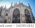 The beautiful back and spire of Milan Cathedral soaring against the blue sky. 142951832