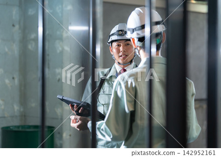 Architects meeting at a construction site Architects meeting at a construction site 142952161