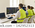 Back view of logistics dispatchers at dashboards, monitoring transport analytics 142952313