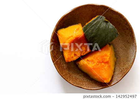 A top-down view of simmered pumpkin against a white background. A top-down view of simmered pumpkin against a white background. 142952497