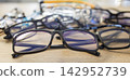 Assorted prescription eyeglasses and stylish frames arranged for customer choice 142952739