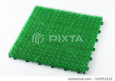 Joint-type artificial turf mat on a white background. Joint-type artificial turf mat on a white background. 142952810