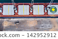 Aerial view of cargo ship at port with cranes and helipad, showcasing maritime transport and logistics. illustrating global trade, shipping industry, and port operations. 142952912