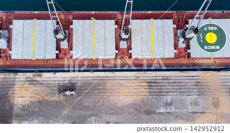 Aerial view of cargo ship at port with cranes and helipad, showcasing maritime transport and logistics. illustrating global trade, shipping industry, and port operations. Aerial view of cargo ship at port with cranes and helipad, showcasing maritime transport and logistics. illustrating global trade, shipping industry, and port operations. 142952912