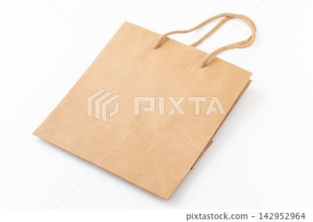 Plain kraft paper tote bag placed against a white background. Plain kraft paper tote bag placed against a white background. 142952964