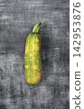 Fresh zucchini on wood with a farm setting, showing organic food produce suitable for seasonal harvest, agriculture, and content. 142953876
