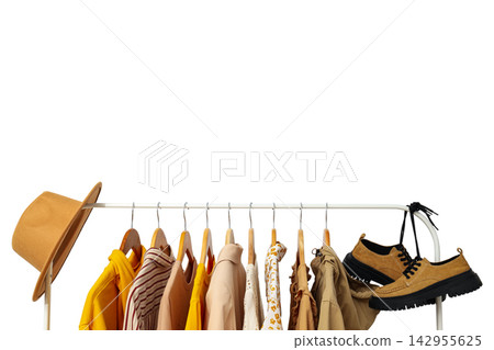 Fall clothing. Casual autumn clothing hangs neatly on a rack with stylish boots and a hat, PNG Fall clothing. Casual autumn clothing hangs neatly on a rack with stylish boots and a hat, PNG 142955625