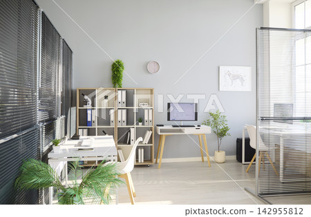 Bright modern veterinary clinic office interior with computer, plants and blinds Bright modern veterinary clinic office interior with computer, plants and blinds 142955812
