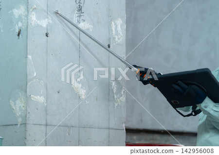 A building inspector inspecting the walls at a construction site. A building inspector inspecting the walls at a construction site. 142956008