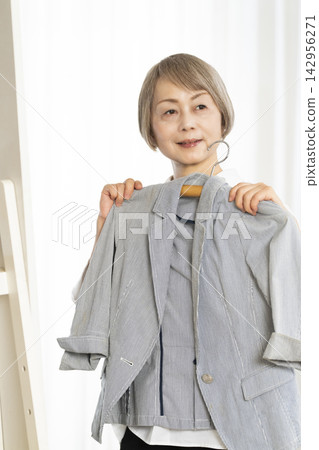 選擇衣裳的資深婦女 選擇衣裳的資深婦女 142956271