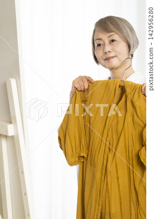Senior woman choosing clothes Senior woman choosing clothes 142956280