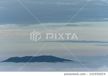 A landscape enveloped in a sea of clouds A landscape enveloped in a sea of clouds 142956854
