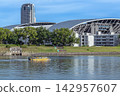 A water taxi operates on the Honkawa River under a clear blue sky. 142957607