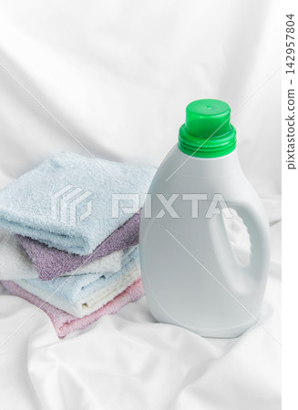 Laundry detergent bottle with clean folded towels Laundry detergent bottle with clean folded towels 142957804