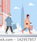 Elderly couple shopping in winter city street with snow falling and tall building in distance 142957857