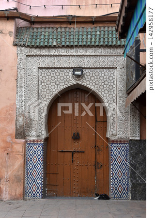 Traditional Moroccan wooden door in Marrakech Medina 142958177