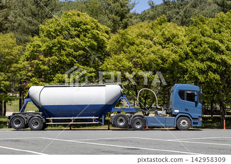 A large tractor unit coupled with a bulk cement trailer (BCT) 142958309