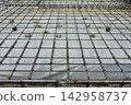 Building foundation work, rebar placement 142958737