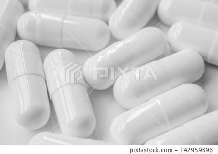 White medicine pills capsule on white background White medicine pills capsule on white background 142959396