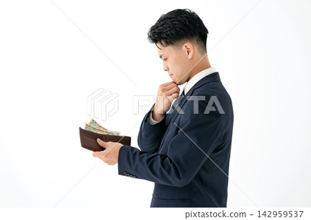 A young man with no money wearing a suit. A young man with no money wearing a suit. 142959537