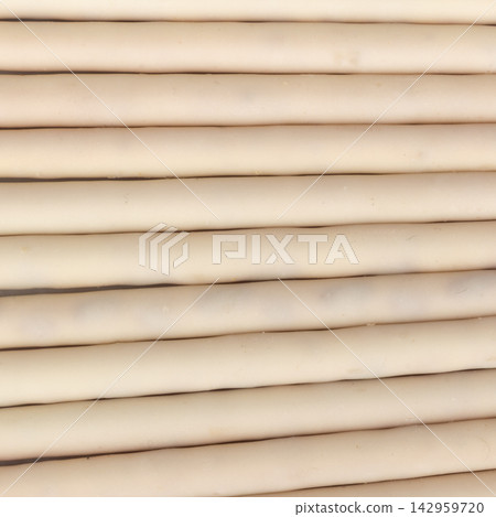 White chocolate coated biscuit sticks texture background wall White chocolate coated biscuit sticks texture background wall 142959720