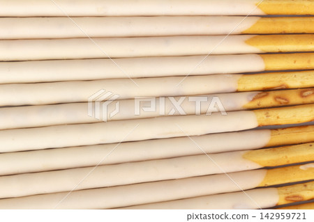White chocolate coated biscuit sticks texture background wall White chocolate coated biscuit sticks texture background wall 142959721