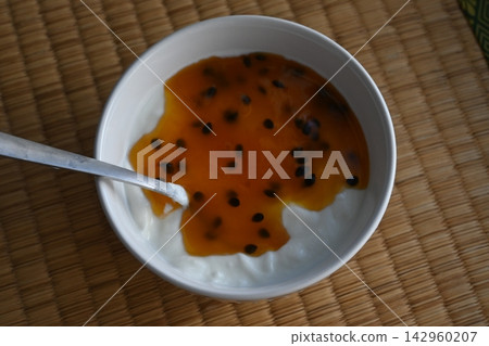 Yogurt (with passion fruit sauce) placed on a tatami mat. Yogurt (with passion fruit sauce) placed on a tatami mat. 142960207