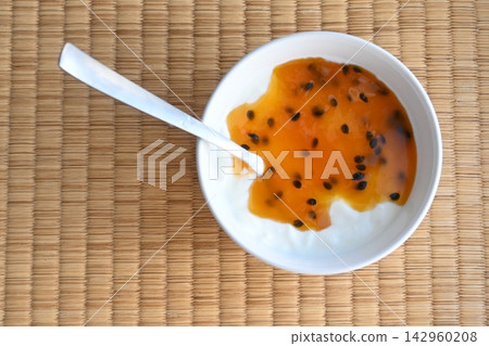 Yogurt (with passion fruit sauce) placed on a tatami mat. Yogurt (with passion fruit sauce) placed on a tatami mat. 142960208