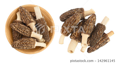 raw morel mushroom in wooden bowl isolated on white background with full depth of field. Top view. Flat lay. raw morel mushroom in wooden bowl isolated on white background with full depth of field. Top view. Flat lay. 142961145