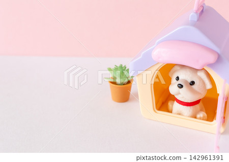 A dog sitting in a pet house/kennel. A dog sitting in a pet house/kennel. 142961391