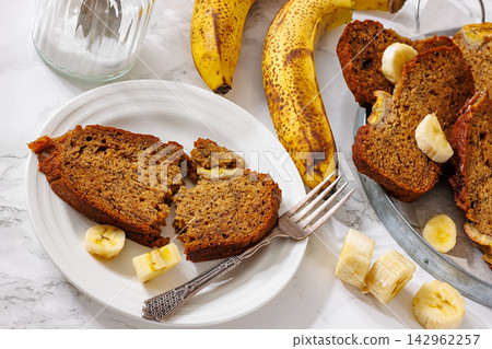 Banana spice bread slices served on a white plate Banana spice bread slices served on a white plate 142962257