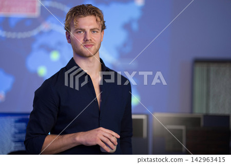 Male Engineer Working in a Control Room with Digital Map Display 142963415