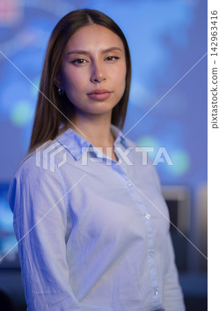 Confident professional woman in a high-tech control room environment 142963416