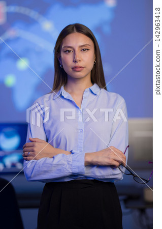Confident female professional in a modern technology monitoring environment Confident female professional in a modern technology monitoring environment 142963418