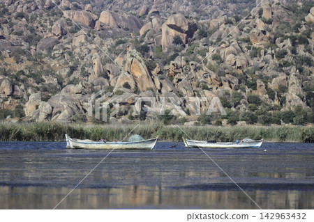 Fishing boats moored along the shore of Lake Bafa in Turkey. Selective Focus. Fishing boats moored along the shore of Lake Bafa in Turkey. Selective Focus. 142963432