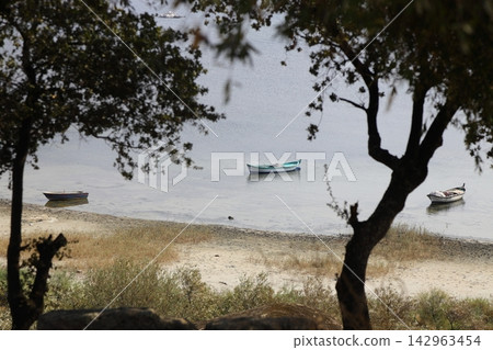 Fishing boats moored along the shore of Lake Bafa in Turkey. Selective Focus. 142963454