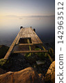 old, rusty abandoned and dismantled pier. sky space is empty. suitable for writing. Seaside town of Turgutreis and spectacular sunshine. Long Exposure shoot. tranquility scene. 142963512