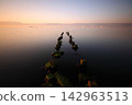 old, rusty abandoned and dismantled pier. sky space is empty. suitable for writing. Seaside town of Turgutreis and spectacular sunshine. Long Exposure shoot. tranquility scene. 142963513