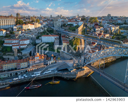 Sunrise drone view of tram on Dom Luis I Bridge over the historic center Sunrise drone view of tram on Dom Luis I Bridge over the historic center 142963903