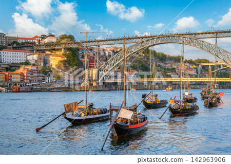 Porto rabelo boats on Douro River by Ribeira, barrel cargo detail Porto rabelo boats on Douro River by Ribeira, barrel cargo detail 142963906