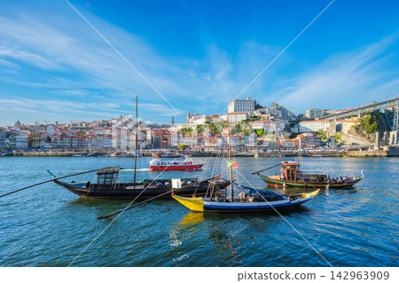 Porto rabelo boats on Douro River by Ribeira, waterfront angle Porto rabelo boats on Douro River by Ribeira, waterfront angle 142963909