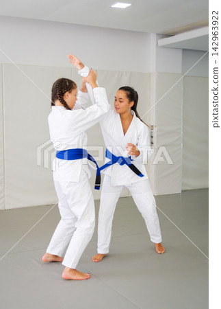 Jiu jitsu students practicing a standing self defense entry Jiu jitsu students practicing a standing self defense entry 142963922